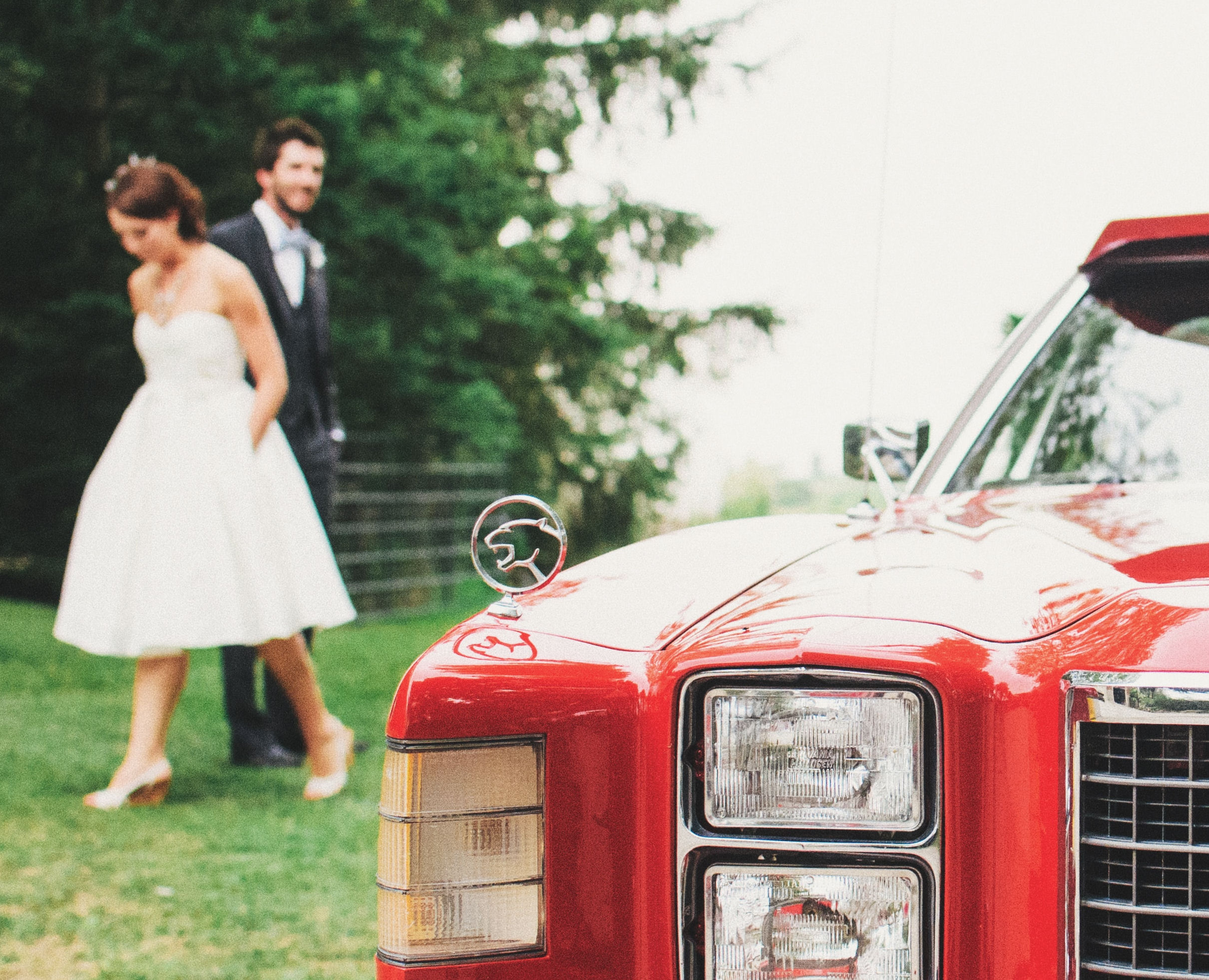 First Look groom
behind bride with red car