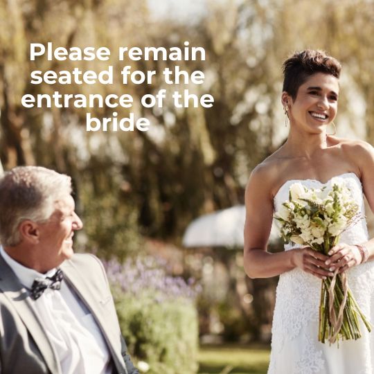 Bride
walking down the aisle with a big smile and a
bouquet clutched in both hands being observed by a
seated male guest